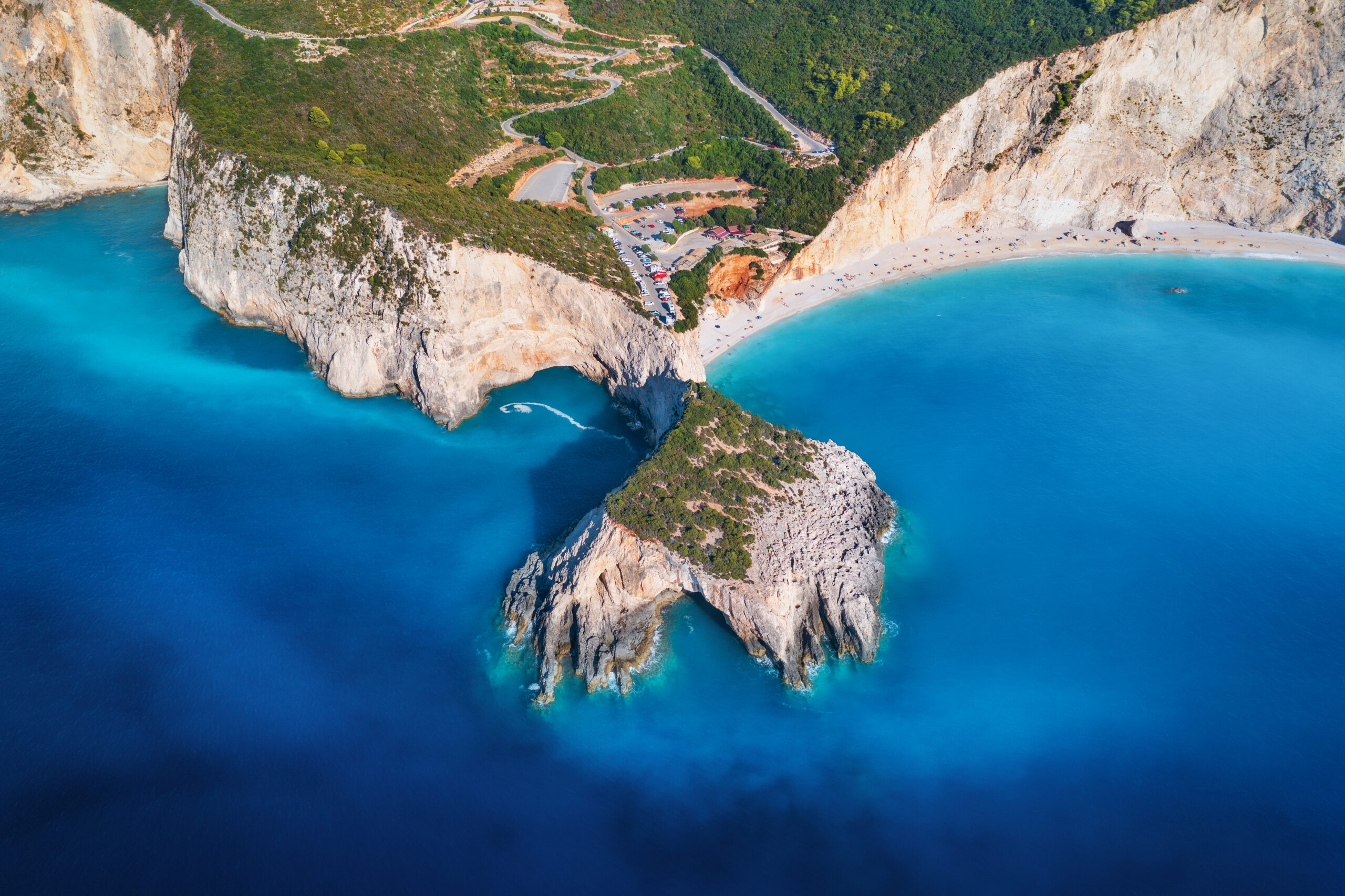 aerial view of blue sea, mountains, white sandy beach at sunrise