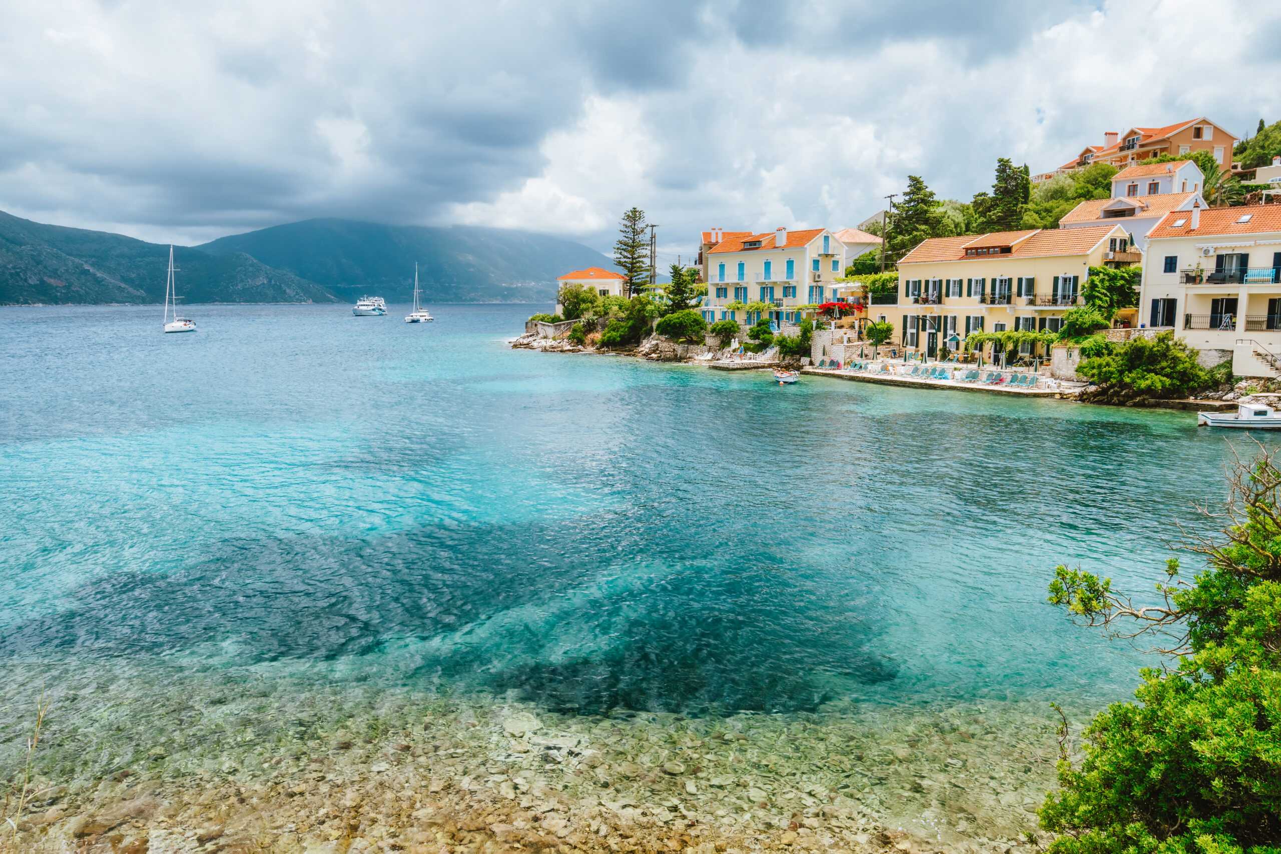 fiskardo village with beautiful clouds above on kefalonia island, greece