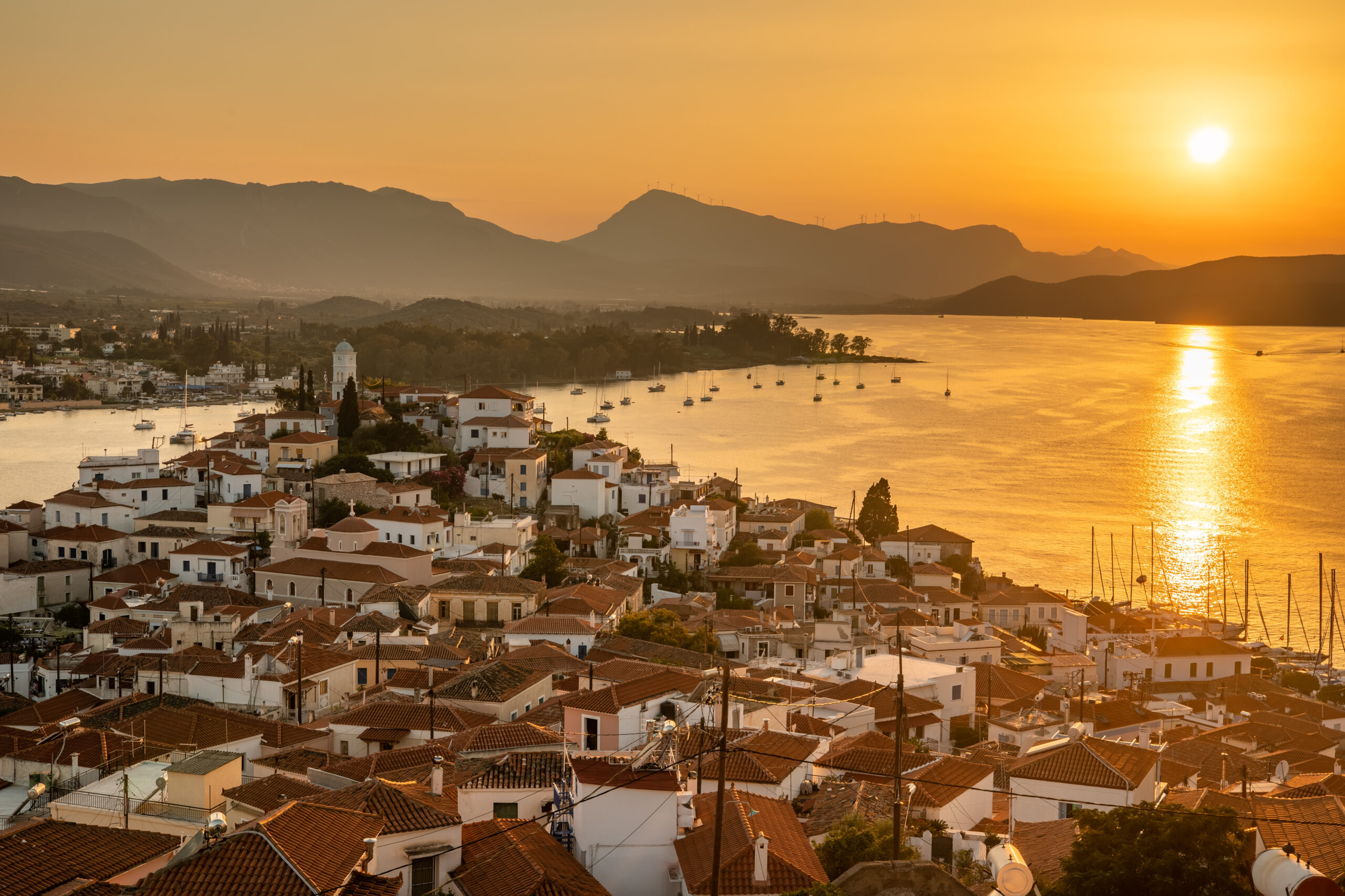 sunset on poros island in aegean sea, greece