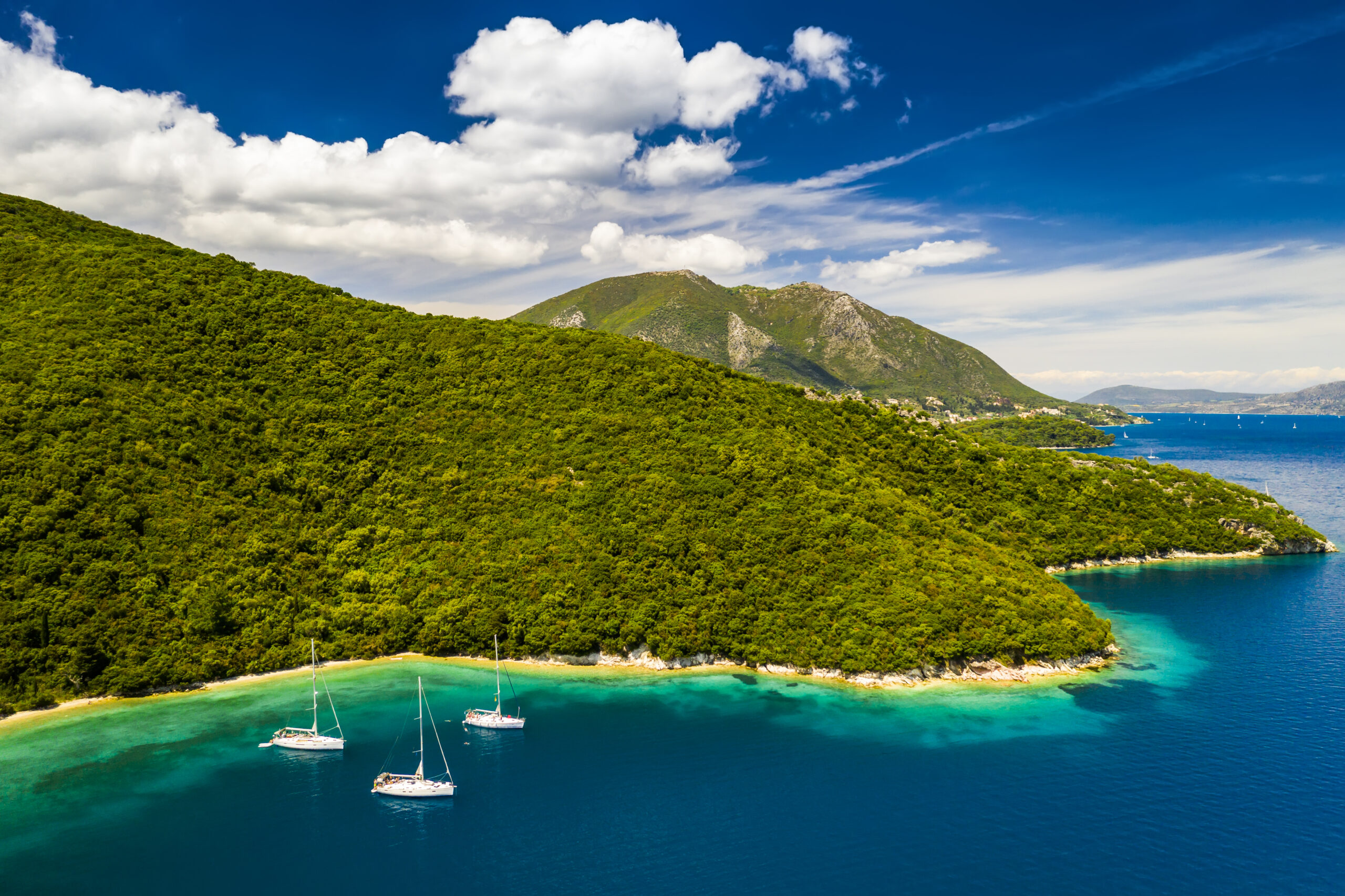 yachts in the bay near the green island. summer vacation, greece, kefalonia.